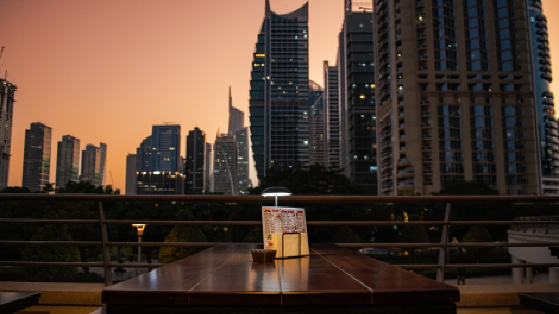 Kima Izakaya outdoor terrace table at sunset with JLT Dubai skyline view in background
