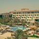Al Raha Beach Resort & Spa beachfront property with swimming pool, sun loungers, palm trees, and resort facilities