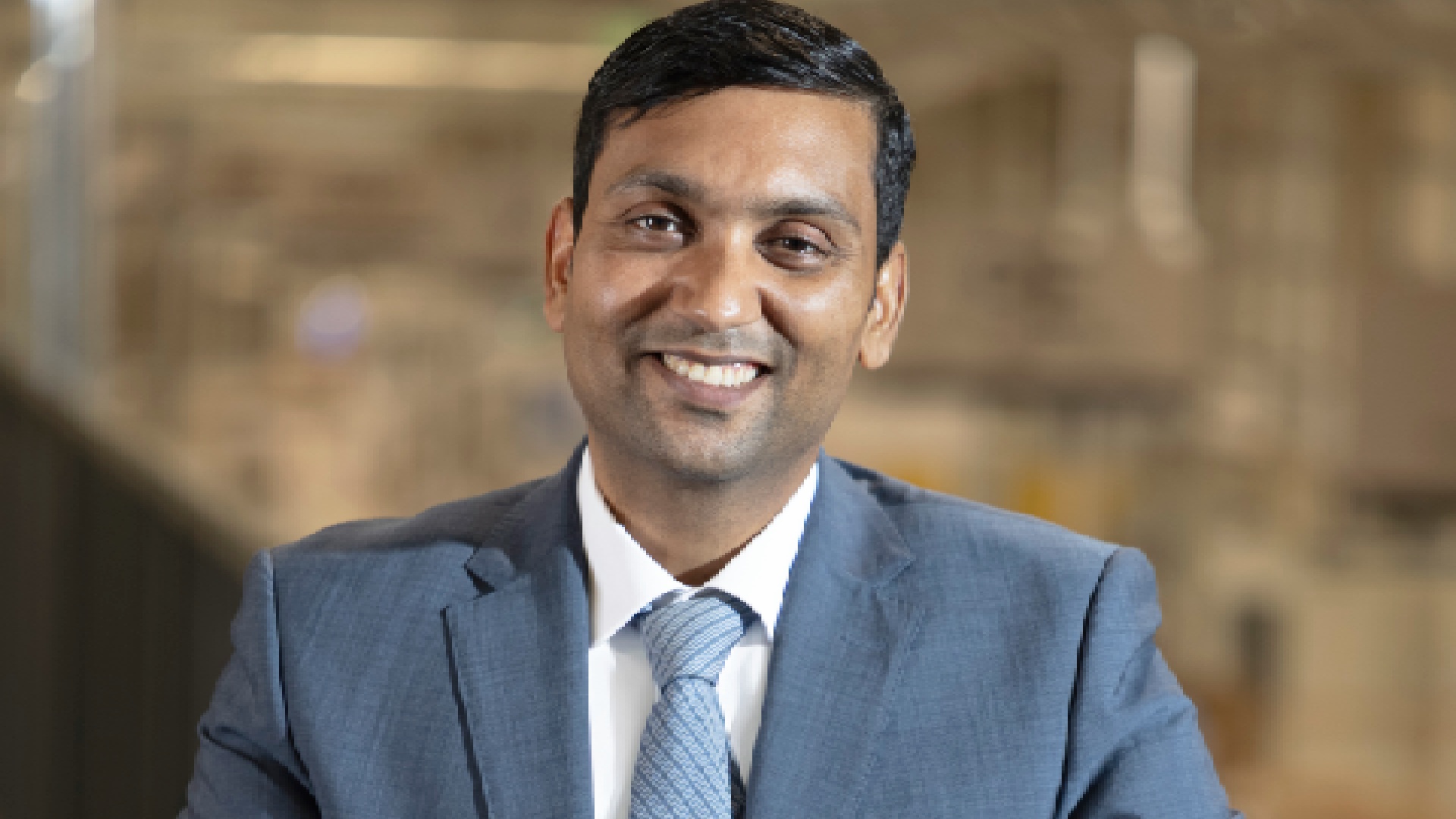 Image 1: "Luxury double-height living room with Sobha Furniture custom cabinetry, neutral upholstery, and modern chandelier" Image 2: "Anuj Jain, CEO of Sobha Furniture, in professional business attire