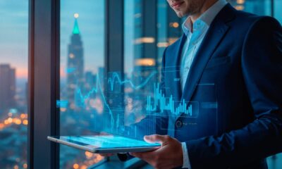 Business professional using tablet with holographic data analytics charts and graphs displayed against city skyline