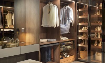 Neatsmith luxury bespoke fitted wardrobe with LED lighting, organized clothing, shoe storage, and handmade wooden finishes in Dubai showroom