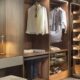 Neatsmith luxury bespoke fitted wardrobe with LED lighting, organized clothing, shoe storage, and handmade wooden finishes in Dubai showroom