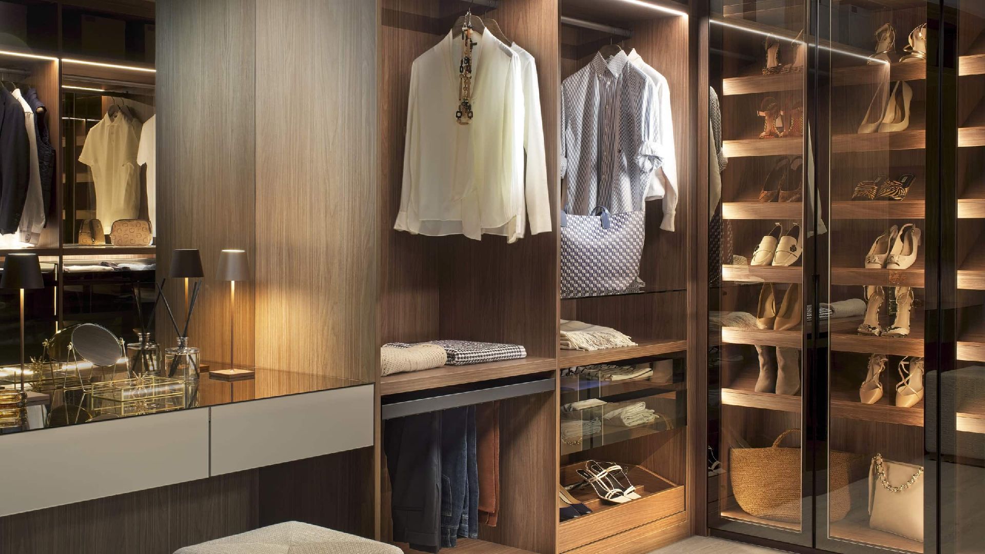 Neatsmith luxury bespoke fitted wardrobe with LED lighting, organized clothing, shoe storage, and handmade wooden finishes in Dubai showroom