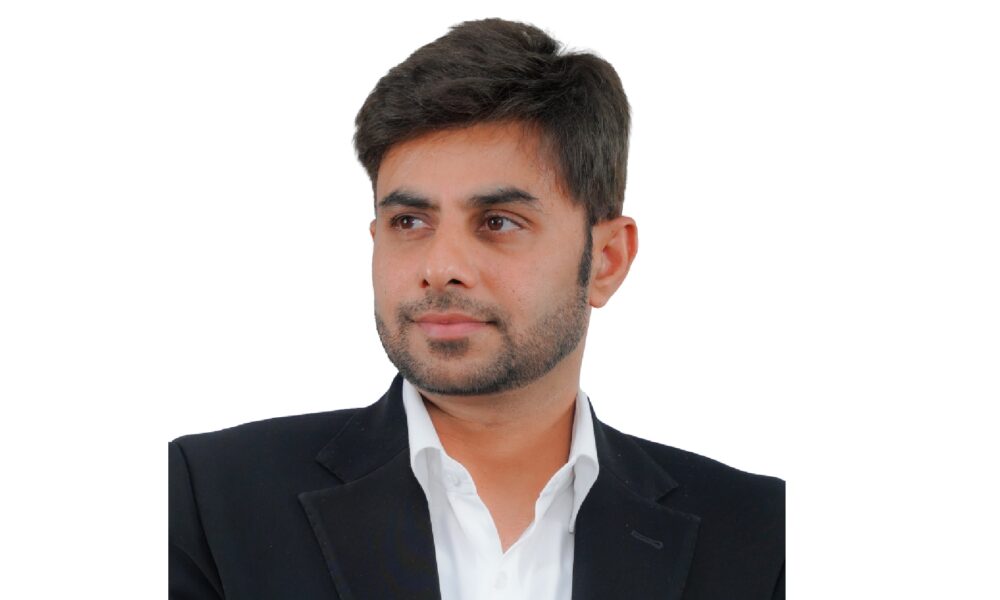 A wide-angle interior shot of a casual, brightly lit PizzaExpress restaurant shows dining tables, a communal bar area, and a large, colorful mural depicting a stylized map of Dubai on the wall.