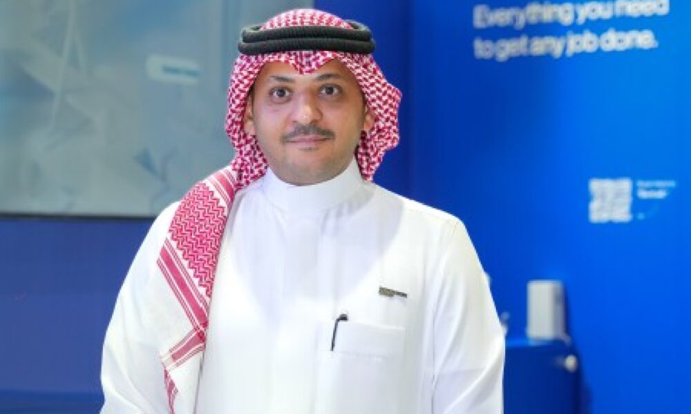 An elegantly set dining room features a modern wooden table, comfortable grey upholstered chairs, a decorative white console table, and abstract wall art, all under soft, ambient lighting.