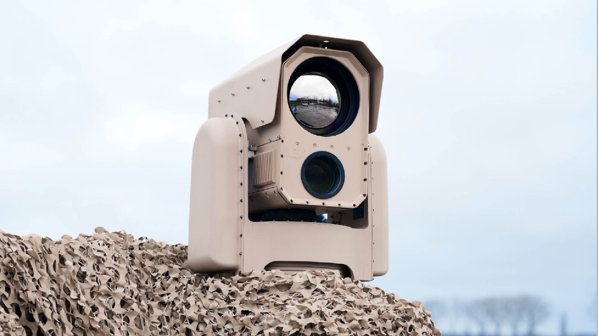 A close-up view of ATERMES' SURICATE AI-enabled multi-sensor surveillance camera system, featuring an optical lens and sensor housing.