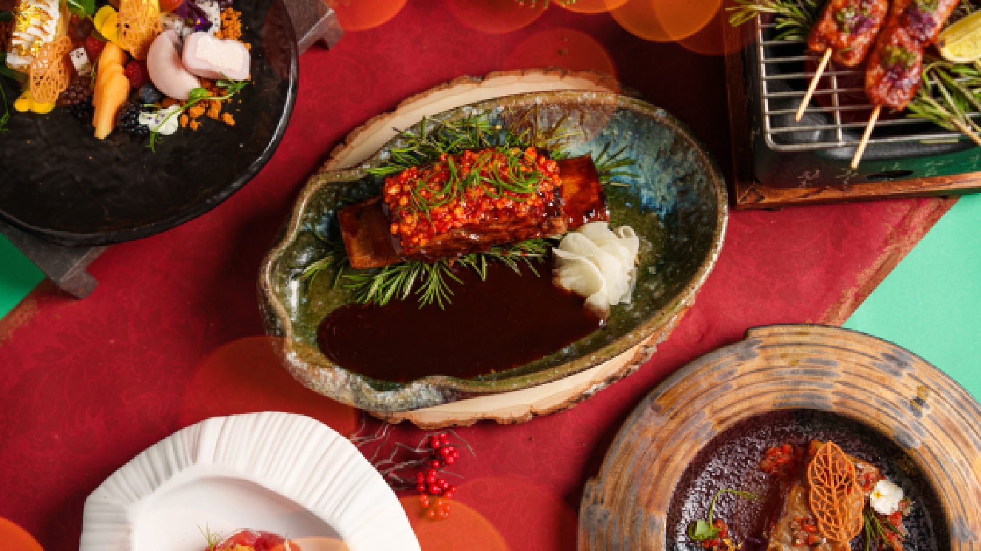 A close-up of a meticulously plated OAnjo Nikkei dish, possibly a festive tuna ceviche or tiradito, garnished with edible flowers and vibrant Peruvian accents.