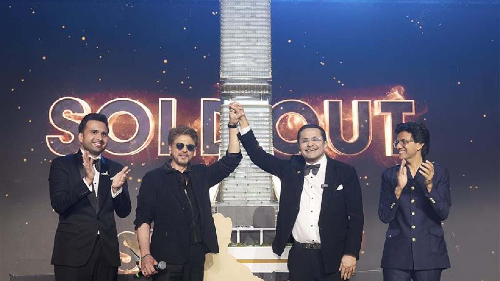 Bollywood superstar Shah Rukh Khan and Danube Group Chairman Rizwan Sajan shaking hands on stage at the launch event of the SHAHRUKHZ by Danube commercial tower in Dubai.