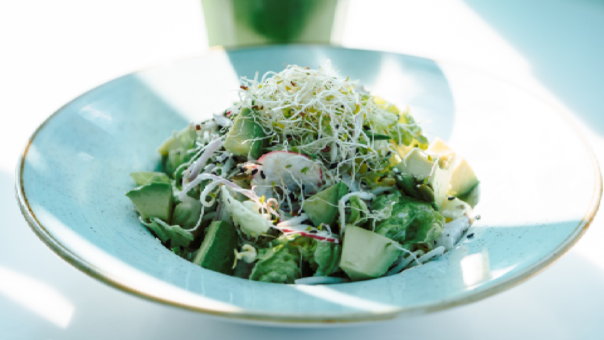 The Tuscan Garden Salad from SKM’D Café, showing a colorful, crisp mix of baby gem, sprouts, red radish, and healthy seeds, elevated with a creamy Italian dressing.
