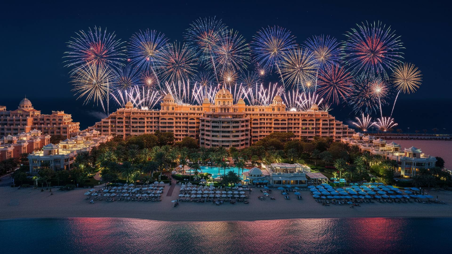 Spectacular white fireworks exploding over the Atlantis, The Palm hotel and resort building at night.