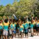 An aerial shot of hundreds of snorkelers gathered in the shallow turquoise water near the house reef at Siyam World Maldives, participating in the Guinness World Record attempt