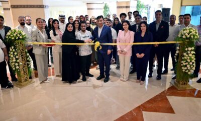many people in one for the ceremony cutting with a ribbon