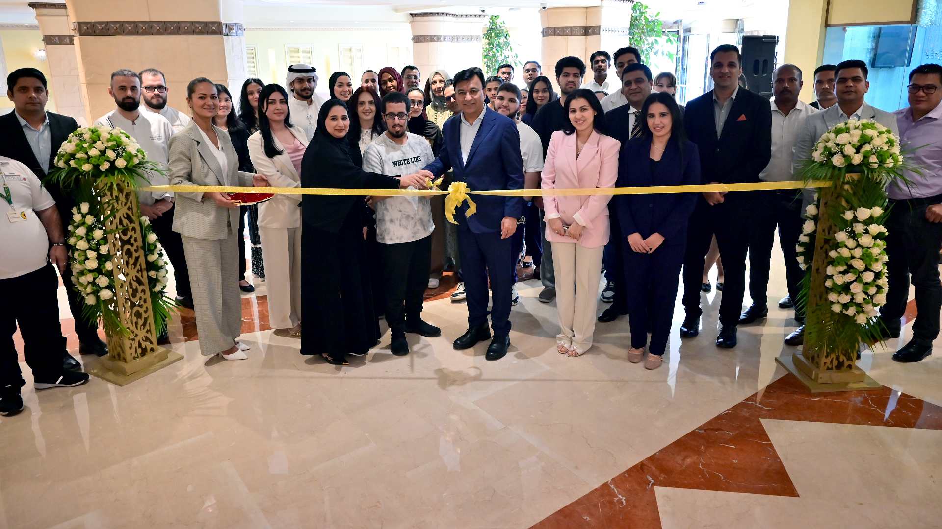 many people in one for the ceremony cutting with a ribbon