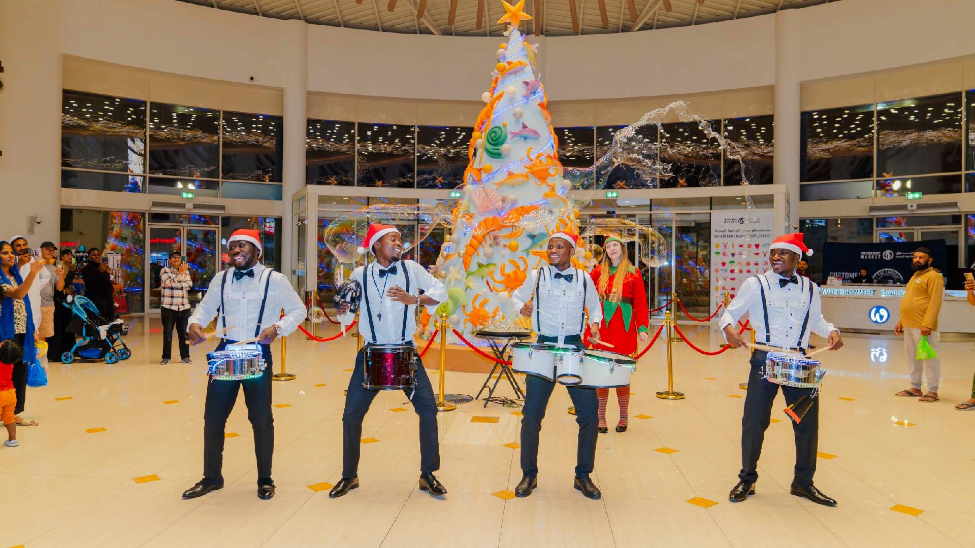 A vibrant, colorful display of fresh whole fish and various seafood arranged on ice at a counter within the Waterfront Market, showcasing the wide variety of catches
