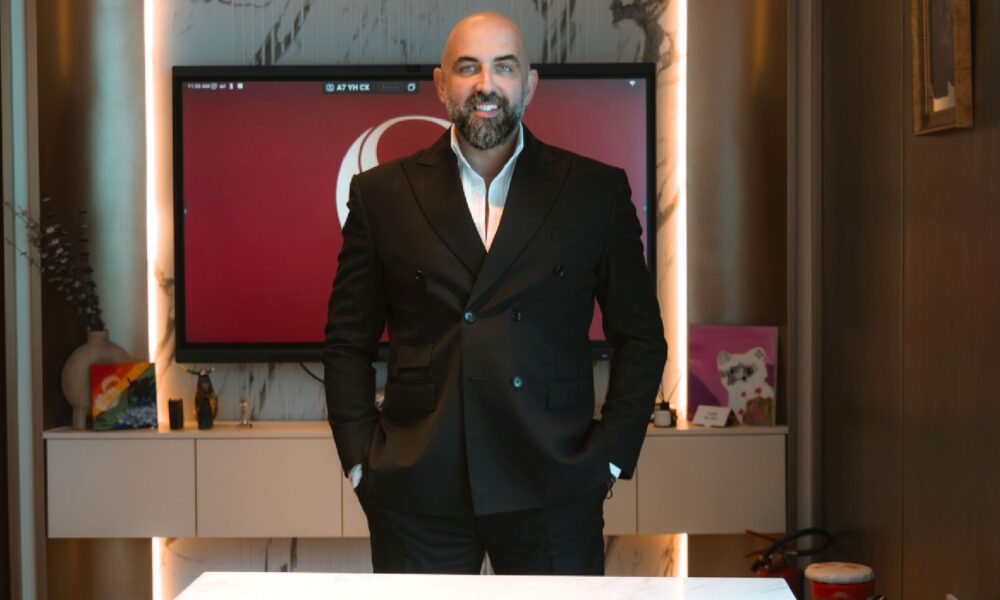A professional headshot of Hisham El Assaad, Founder of OSUS Properties, dressed in a formal suit and looking directly at the camera