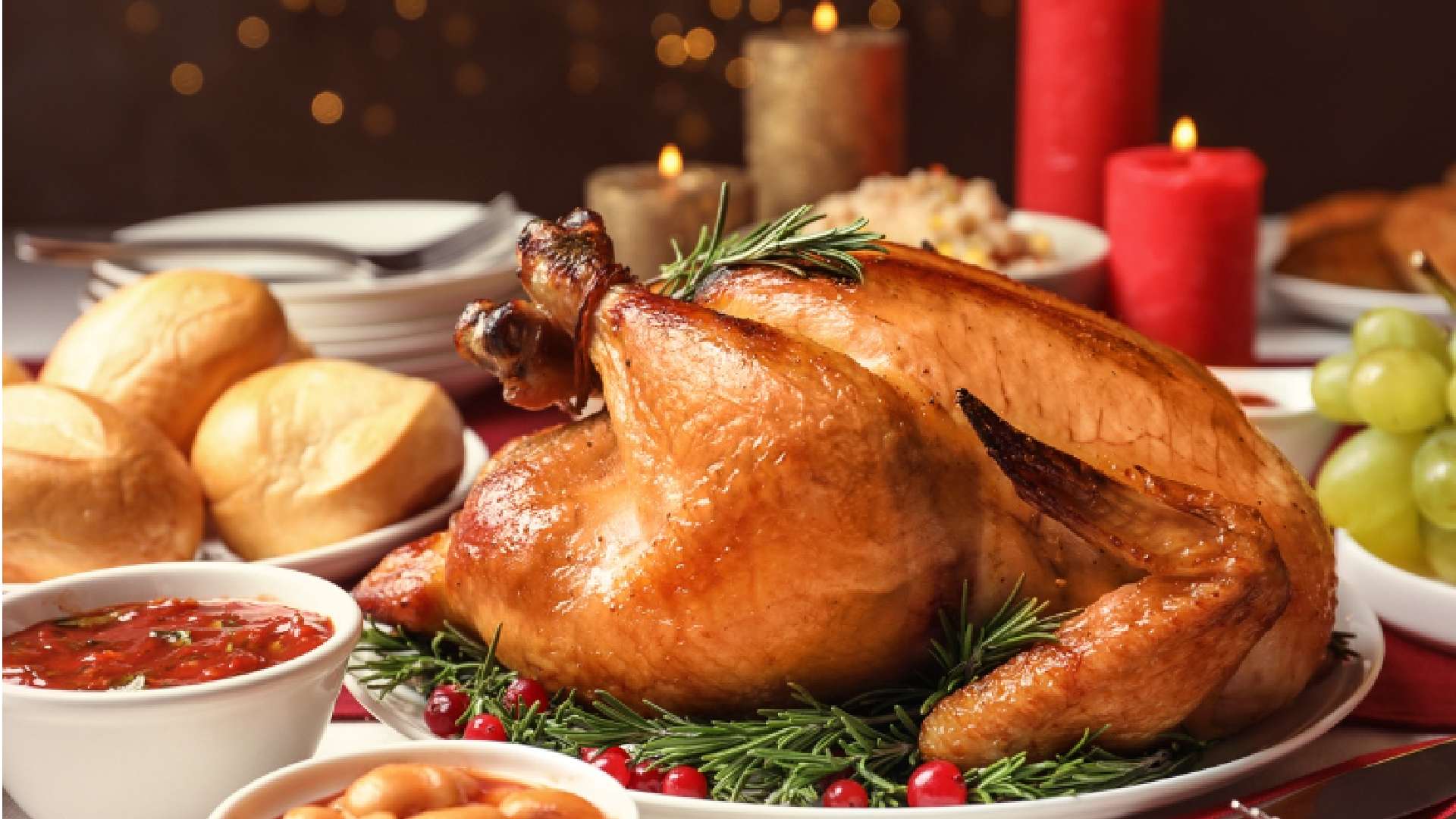 A festive whole roasted turkey from ARCADE EATERY & BAR, served on a platter surrounded by a colorful assortment of roasted root vegetables and classic holiday side dishes.