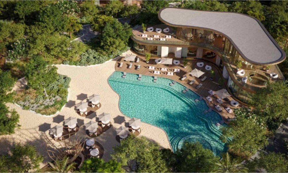 An aerial architectural rendering of SIORA by BEYOND Developments on Dubai Islands, highlighting the curved residential buildings, extensive green landscaping, and the continuous 6km coastline and beach