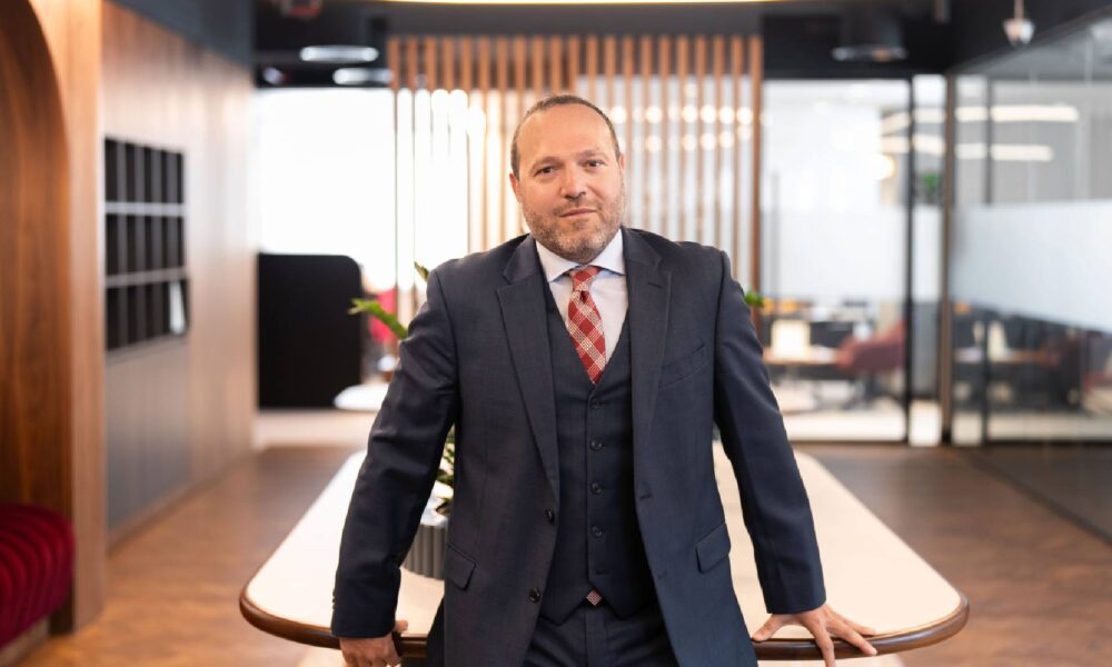 A professional portrait of Ayman Ezzeddine, Director of Development for Middle East, Egypt, and Pakistan at Radisson Hotel Group, captured during an interview at the Future Hospitality Summit