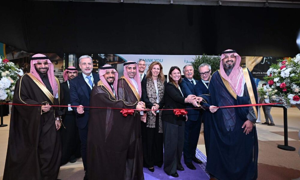 Ribbon-cutting ceremony at HORECA event with officials and organizers standing in front of floral arrangements, marking the official opening of the hospitality exhibition