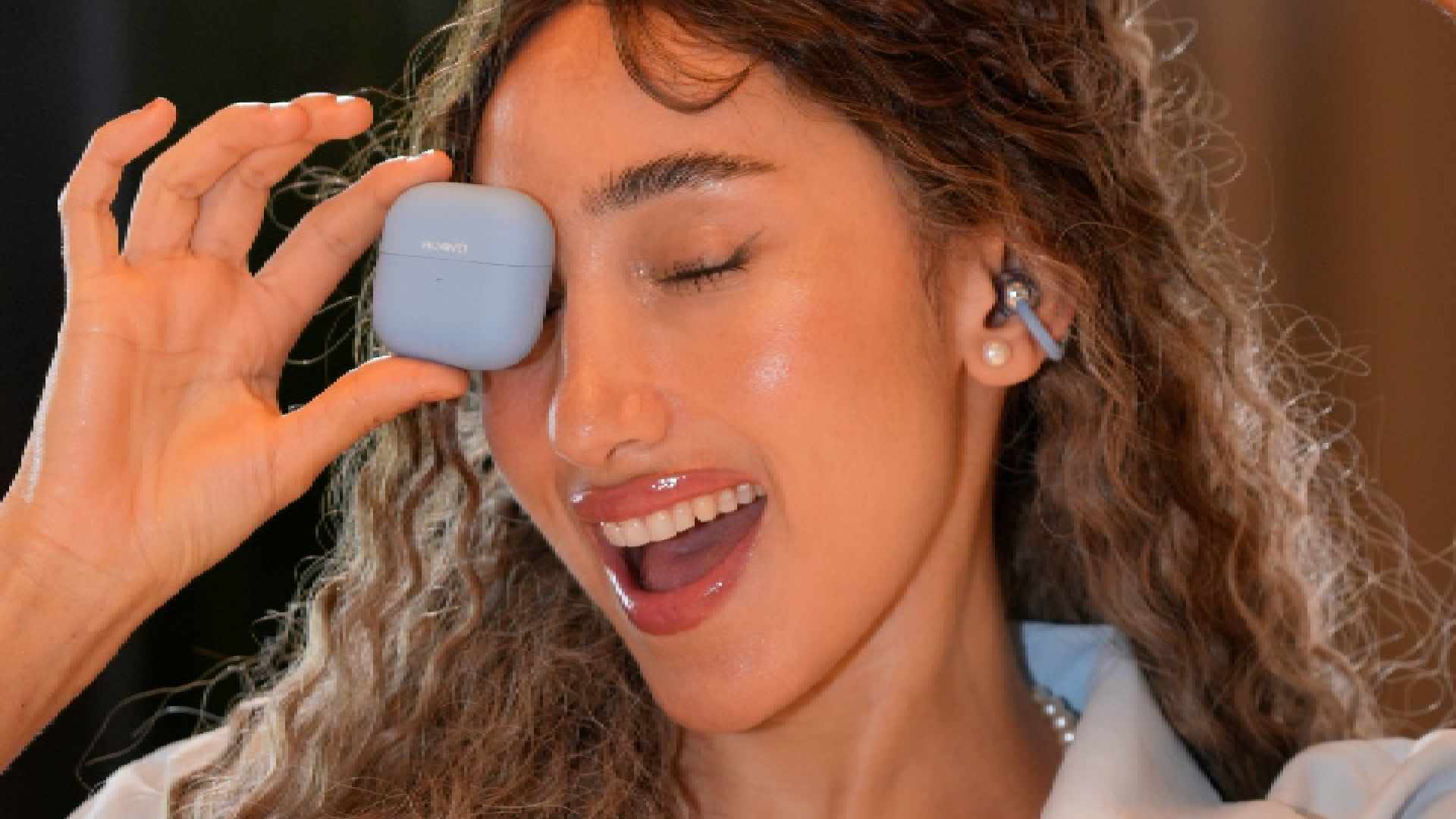 A lifestyle product photograph of the HUAWEI Mate XT ULTIMATE DESIGN, the world’s first commercially available trifold smartphone, being unfolded from its 6.4-inch phone size to its full 10.2-inch 3K display.