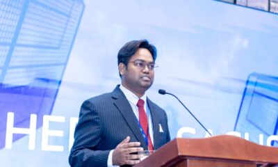 A close-up photograph of a partially obscured electronic money transfer slip, showing the name of the sender, the receiving bank's name, and a blurred handwritten signature, often used in online fraud attempts.