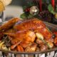 A festive whole roasted Christmas turkey (7-8kg) from BAB EL BAHR, served on a platter with chestnut stuffing and a medley of roasted seasonal vegetables for the holiday offering
