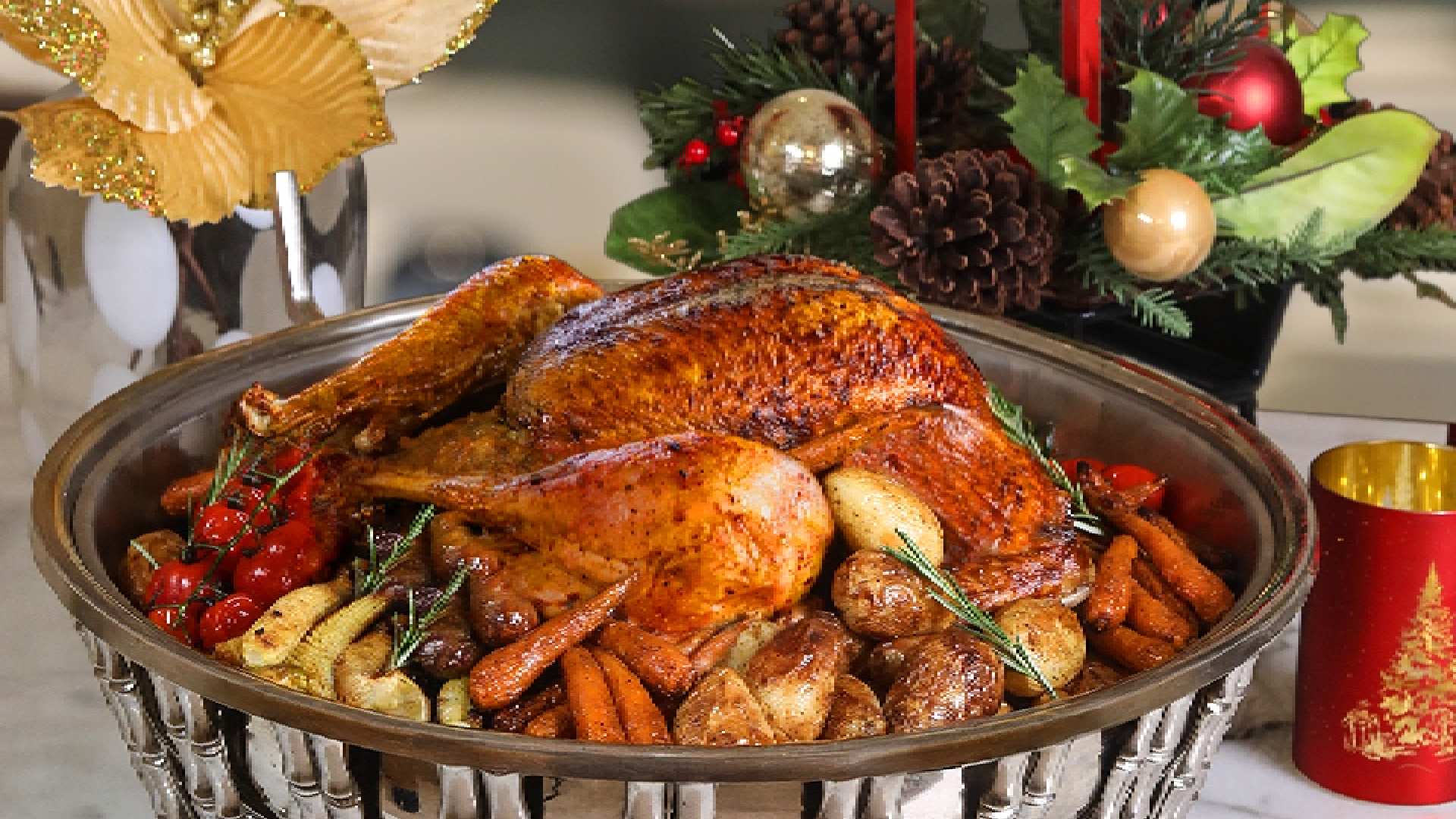 A festive whole roasted Christmas turkey (7-8kg) from BAB EL BAHR, served on a platter with chestnut stuffing and a medley of roasted seasonal vegetables for the holiday offering