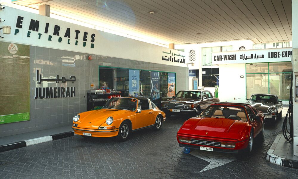 Classic cars at an Emirates Petroleum Jumeirah gas station.