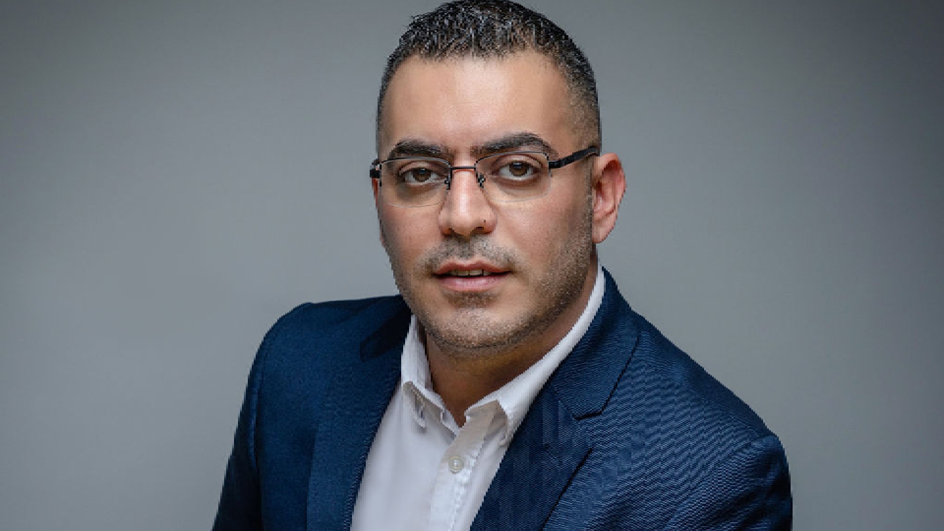 A vibrant, modern booth at an exhibition features a large, colorful display promoting "Kerry Unboxed," with food samples, professional chefs in white jackets, and several people gathered around.