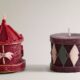 Decorative scented candles shaped like a gingerbread house, a nutcracker, and a Christmas tree, part of the Zara Home winter fragrance collection.