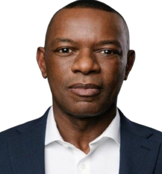 Person wearing a dark navy business suit over a white collared shirt, photographed against a plain white background. The image is a professional corporate portrait used for Enterprise DB branding