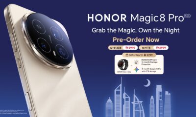 A promotional pre-order graphic for the HONOR Magic8 Pro 5G smartphone in a beige/gold color, showcasing the large circular rear camera module. The title reads "Grab the Magic, Own the Night. Pre-Order Now." It lists two configurations and prices: 12+512GB at 3999 (currency symbol looks like an inverted, stylized 'B') and 16+1TB at 4999. It also details pre-order gifts worth 2299, which include the HONOR Watch 5 Ultra, 12-month HONOR VIP Care damage protection, and 3-month Google AI Pro with 2TB storage. A stylized silhouette of the Dubai skyline is visible at the bottom.