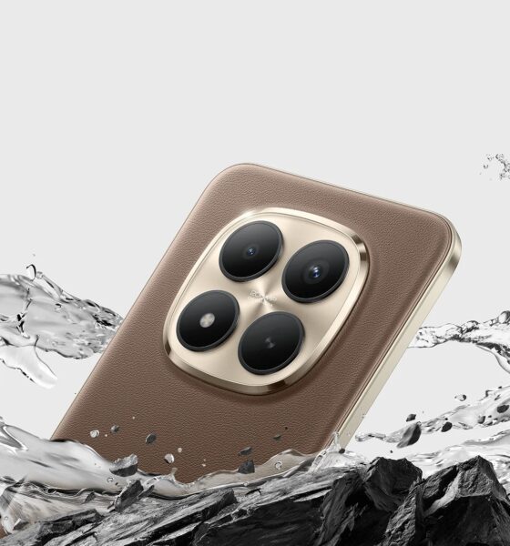Official promotional image of the Xiaomi Redmi Note 15 Pro+ in Mocha Brown. The phone features a premium eco-leather back and a large circular gold-rimmed quad-camera module. It is shown dramatically splashing through water and dark jagged rocks to highlight its IP69K water resistance and Titan Durability.