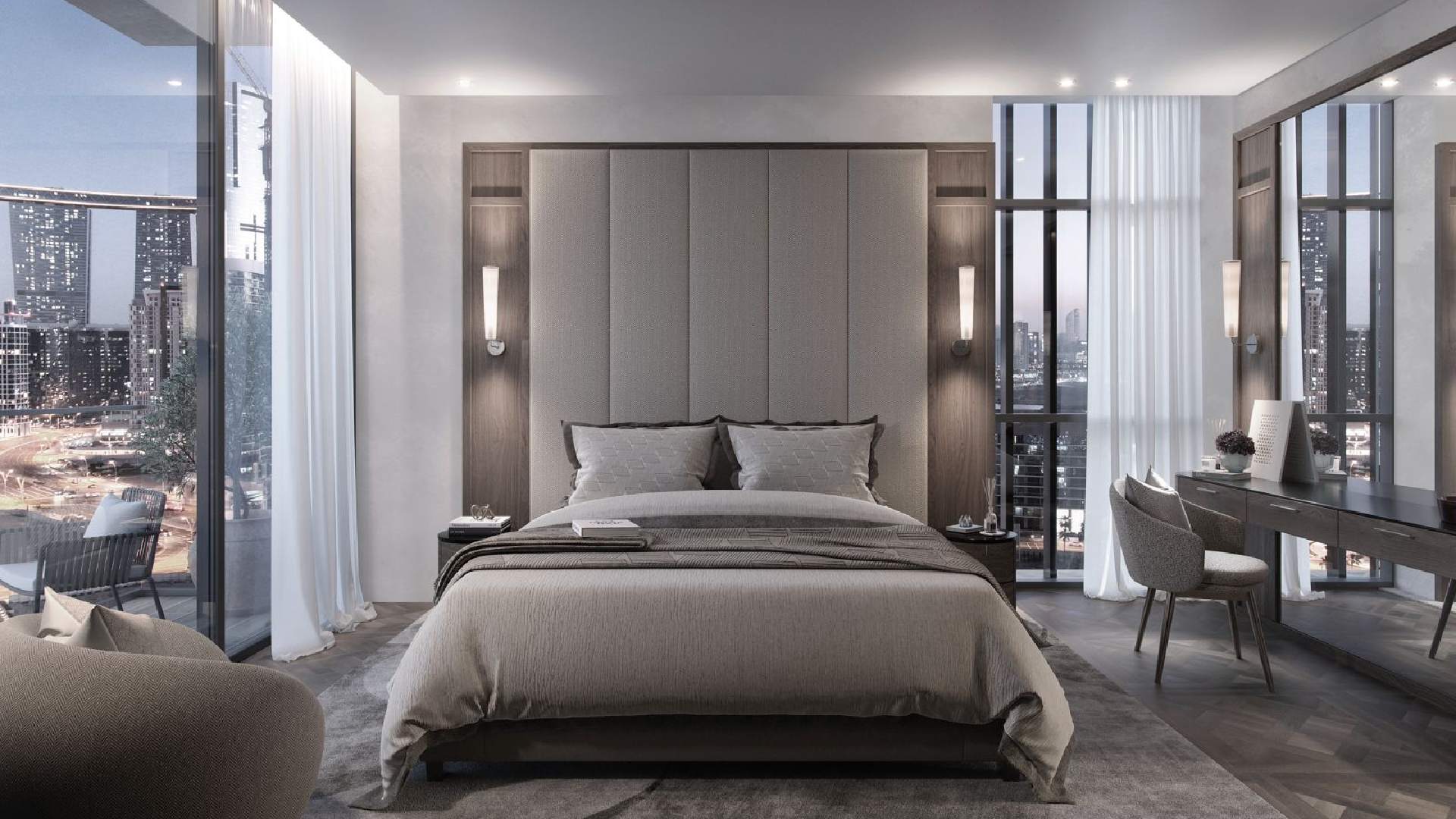 Modern luxury bedroom interior with a large upholstered headboard, neatly made bed with gray bedding, bedside tables with wall-mounted lights, floor-to-ceiling windows offering city skyline view, and a sleek dressing table with chair