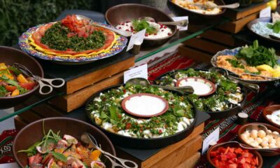 A vibrant Ramadan buffet display at Mövenpick Hotel featuring assorted Middle Eastern salads, fresh vegetables, mezze dishes, and bowls of colorful ingredients arranged neatly on wooden risers and decorative tableware.