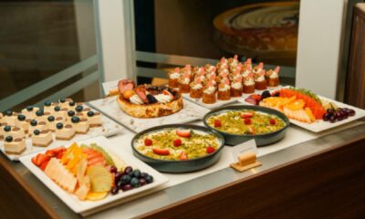 Iftar dessert and fruit buffet display at MÖVENPICK DOWNTOWN featuring assorted cakes, mini pastries, fresh fruit platters, and traditional Ramadan desserts arranged on a serving counter.