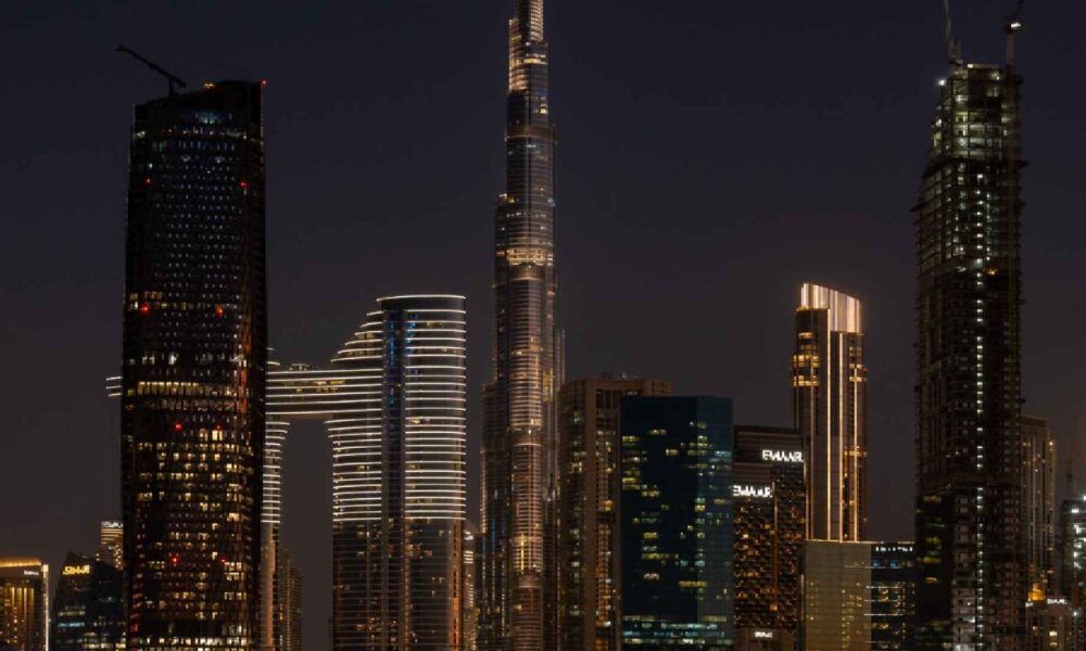 Nighttime cityscape view from LA VILLE HOTEL & SUITES showing the illuminated Burj Khalifa and Downtown Dubai skyline.