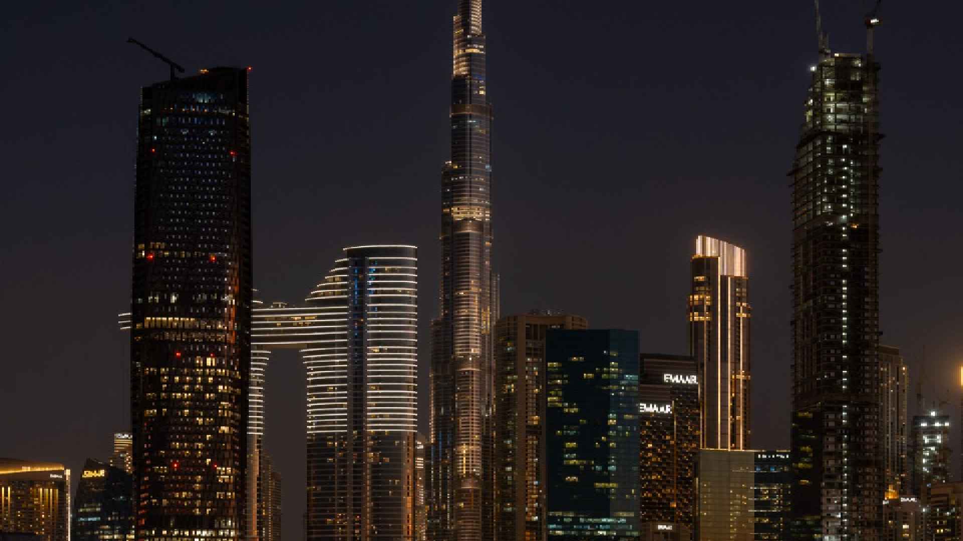 Nighttime cityscape view from LA VILLE HOTEL & SUITES showing the illuminated Burj Khalifa and Downtown Dubai skyline.