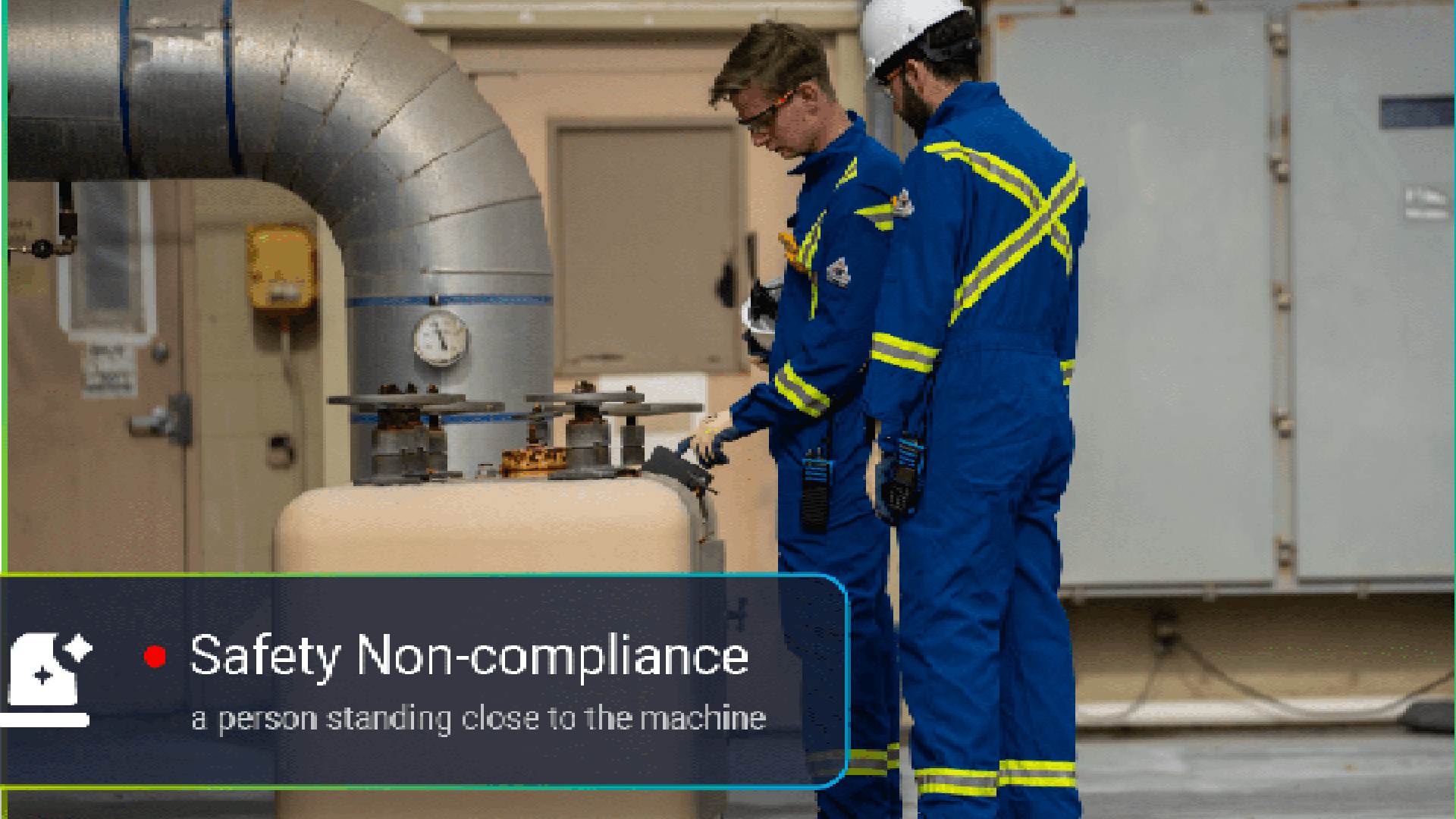 wo workers in blue safety uniforms with reflective stripes standing near industrial machinery and large piping, with an on-screen alert indicating “Safety Non-compliance: a person standing close to the machine