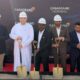 CASAGRAND HERMINA ground breaking ceremony with officials wearing safety helmets holding ceremonial shovels on a red carpet in front of CASAGRAND HERMINA branded backdrop