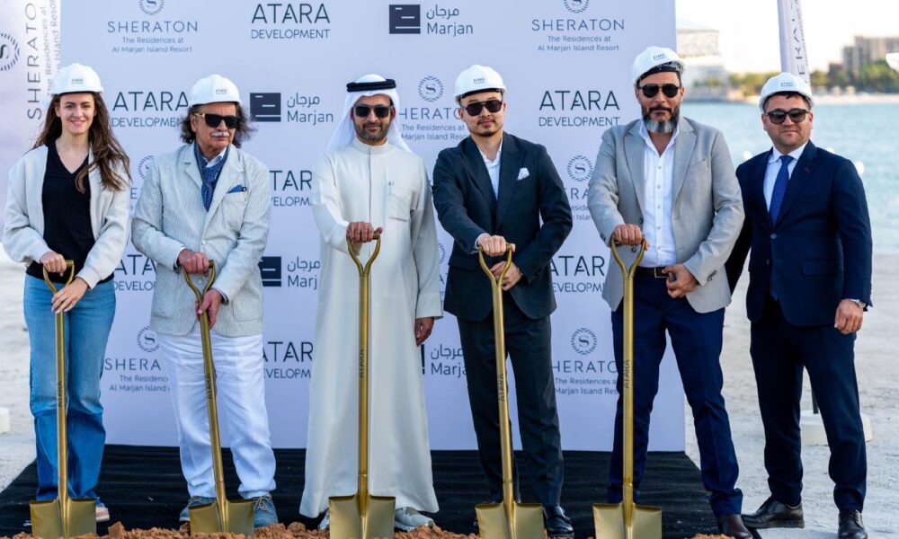 Groundbreaking ceremony for The Residences at Sheraton Al Marjan Island Resort by ATARA Development, featuring six individuals standing on a sandy site holding gold ceremonial shovels in front of a branded backdrop displaying logos of ATARA Development, Sheraton, and Marjan