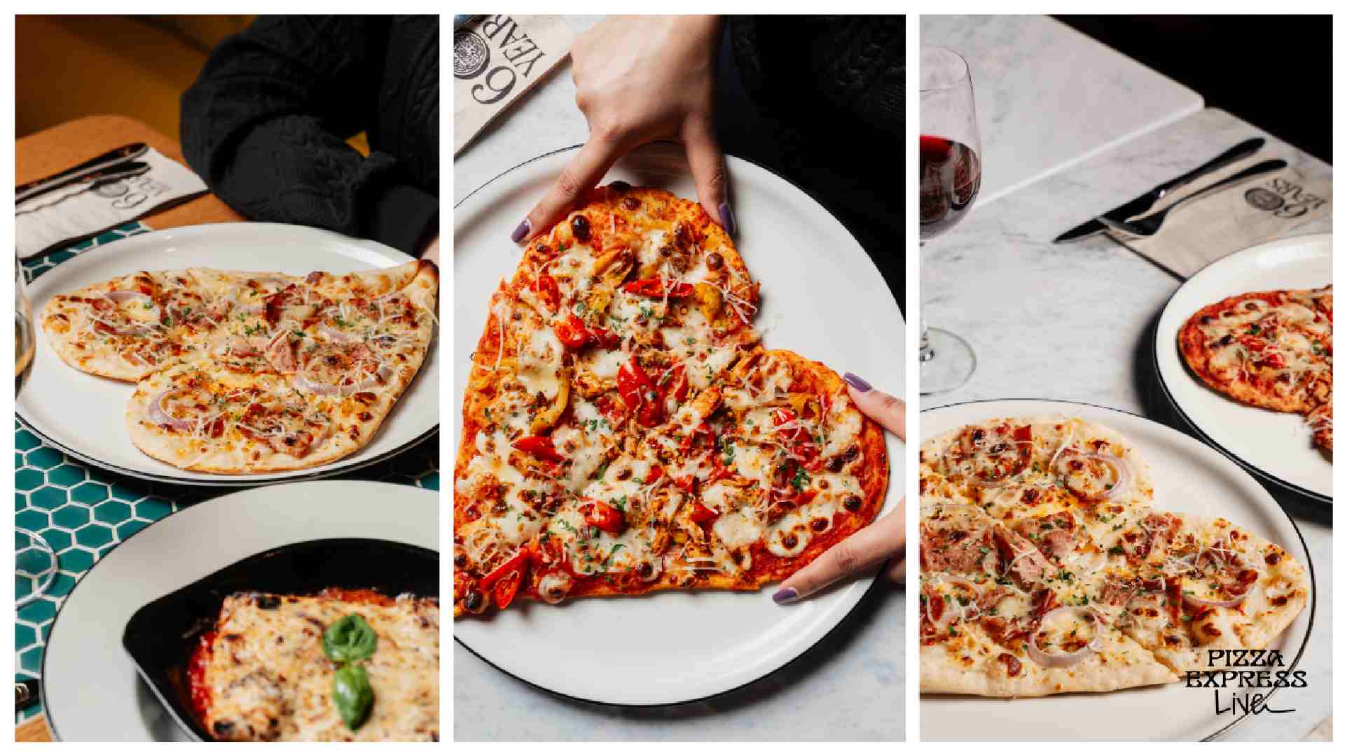 Three PizzaExpress pizzas on white plates, including a heart-shaped pizza being placed on the table by hands, set on a restaurant dining surface with cutlery and wine.
