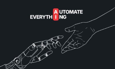 A robotic hand reaching toward a human hand on a dark background, with the words “Automate Everything” and the letters “A” and “I” highlighted in red above them, representing AI innovation from Deriv.