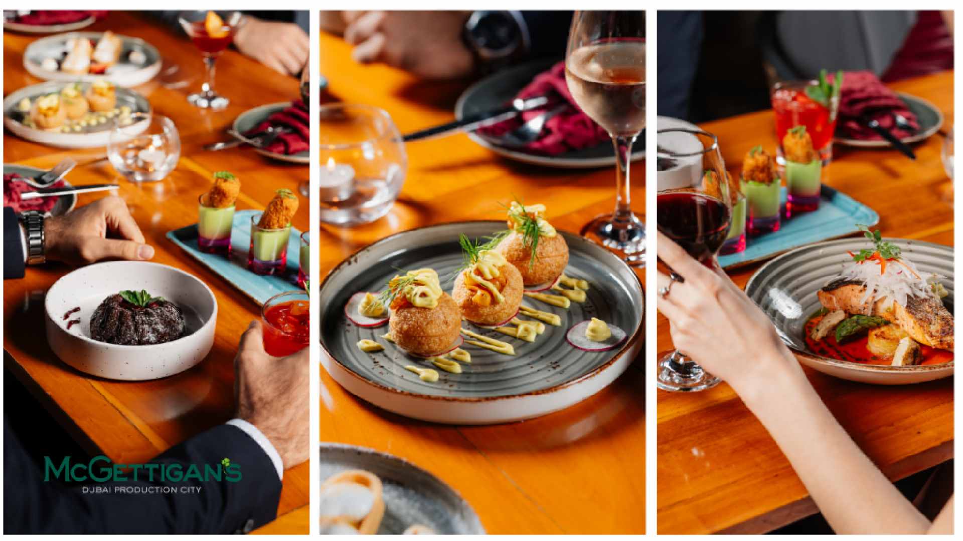 Assorted plated dishes and cocktails on a wooden table at McGettigan’s Dubai Production City, with guests seated and dining, showing appetizers, a main course, drinks, and hands reaching for food.