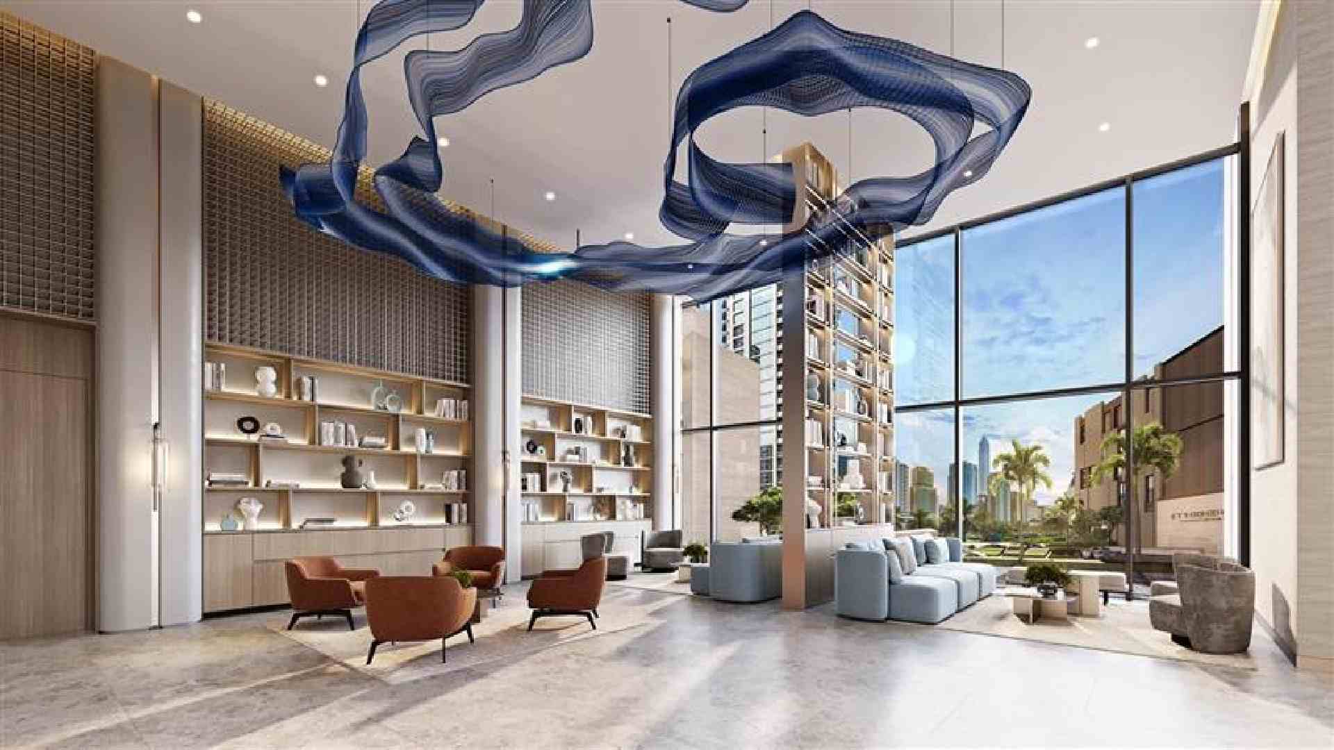 Double-height modern lobby interior by Opaal Interiors featuring floor-to-ceiling windows, sculptural blue suspended ceiling installation, built-in shelving, lounge seating, and city views beyond.
