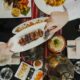 Overhead view of guests sharing a grilled meat platter with dates and Arabic dishes on a table at PARK REGIS KRIS KIN HOTEL DUBAI during Iftar.
