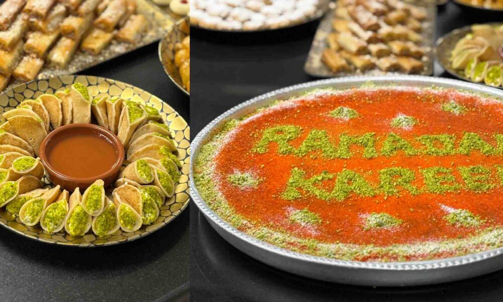 Mediterranean Ramadan dessert display at Holiday Inn Dubai Al Maktoum Airport featuring kataifi, pistachio pastries, and a large tray of knafeh decorated with “Ramadan Kareem” in pistachio powder.