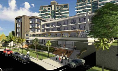 Architectural rendering of Best Western Premier Royal Golf View Kigali showing a modern hotel building with stepped terraces, balconies, landscaped frontage, pedestrians on sidewalks, parked cars, palm trees, and high‑rise residences in the background.