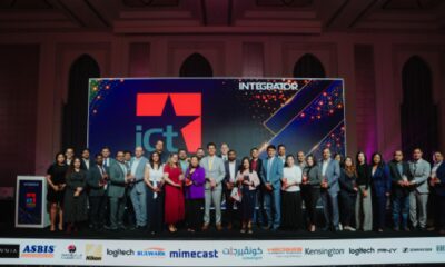 Award winners and industry leaders stand on stage at Integrator Media – the ICT Champion Awards 2026 in Dubai, holding trophies beneath the ICT Champion Awards backdrop.