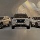 A front-facing lineup of three Nissan SUVs. The X-Trail on the left, the Pathfinder in the center, and the Magnite on the right.